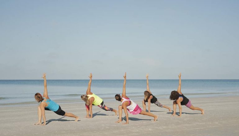 Woman practicing yoga on the beach, Woman practicing yoga o…